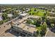 Aerial view of the restaurant, golf course, pool, and surrounding landscape at 9300 E Center Ave # 2B, Denver, CO 80247
