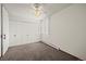 Neutral-toned bedroom featuring a ceiling fan, window, and closet at 9300 E Center Ave # 2B, Denver, CO 80247