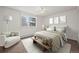 Bright staged bedroom featuring neutral colors and modern furnishings, with a large window at 9300 E Center Ave # 2B, Denver, CO 80247