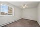 Bright bedroom featuring neutral carpeting, a large window, and bright walls at 9300 E Center Ave # 2B, Denver, CO 80247