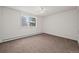 Bright bedroom with neutral carpeting, a large window, and radiator at 9300 E Center Ave # 2B, Denver, CO 80247