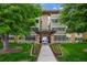 Building entrance with well-manicured landscaping and pathway at 9300 E Center Ave # 2B, Denver, CO 80247