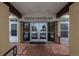 Well-lit entrance to the building with double doors and a covered entryway at 9300 E Center Ave # 2B, Denver, CO 80247