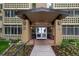 A building entrance with visible address signage and well-maintained landscaping at 9300 E Center Ave # 2B, Denver, CO 80247