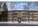 Exterior shot of the building at 9300 Center Ave. with a snow covered lawn at 9300 E Center Ave # 2B, Denver, CO 80247