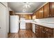 The kitchen features wood cabinetry, efficient appliances, and a functional layout at 9300 E Center Ave # 2B, Denver, CO 80247