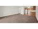 Bright living room featuring an open floor plan and neutral carpeting next to kitchen at 9300 E Center Ave # 2B, Denver, CO 80247