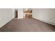 Spacious living room featuring an open floor plan and neutral carpeting at 9300 E Center Ave # 2B, Denver, CO 80247