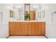 Bathroom featuring a vanity with dual sinks, hardwood cabinets, and a decorative plant in front of the window at 1188 S Sherman St, Denver, CO 80210
