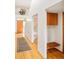 Bright entryway with a coat rack, storage cabinets, and staircase with a wood door and hardwood floors at 1188 S Sherman St, Denver, CO 80210