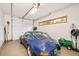 Spacious garage featuring a classic blue car, storage, and epoxy floors at 1188 S Sherman St, Denver, CO 80210