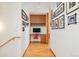 Hallway featuring a built-in desk area with cabinets, hardwood floors, and decorative wall art at 1188 S Sherman St, Denver, CO 80210