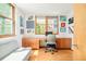 Home office features custom built-in desk and cabinet storage, a modern chair, and a hardwood floor at 1188 S Sherman St, Denver, CO 80210