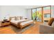 Comfortable main bedroom with wood floors, lots of light, and a sliding glass door to a patio at 1188 S Sherman St, Denver, CO 80210