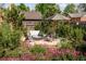 Secluded patio with gray seating arrangement, umbrella, and beautiful landscaping and trees at 1188 S Sherman St, Denver, CO 80210