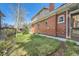 The backyard shows a well-manicured lawn surrounding a brick house at 3777 Newton St, Denver, CO 80211