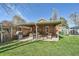 A backyard featuring a covered patio, grill, and outdoor seating on the grass at 3777 Newton St, Denver, CO 80211