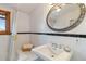 Bright white bathroom featuring a tub and shower combination under a window at 3777 Newton St, Denver, CO 80211