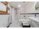 Bright bathroom with white subway tile, black accents, and jacuzzi tub at 3777 Newton St, Denver, CO 80211