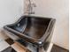 Unique black tub with a decorative finish and modern fixtures at 3777 Newton St, Denver, CO 80211