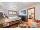 Charming bedroom with hardwood floors, black dresser, and view into adjacent office area at 3777 Newton St, Denver, CO 80211