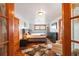 Bright bedroom boasts hardwood floors and access to walk-in closet and attached sitting room at 3777 Newton St, Denver, CO 80211