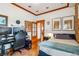 Cozy bedroom features hardwood floors, wood trim, and comfortable desk and bed setup at 3777 Newton St, Denver, CO 80211