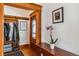 Inviting foyer with hardwood floors, coat rack and a charming glass-paneled front door at 3777 Newton St, Denver, CO 80211