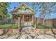 Charming brick home with a wrought iron fence, landscaped yard, and a gated entrance at 3777 Newton St, Denver, CO 80211