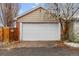 Two car detached garage with blooming tree in front at 3777 Newton St, Denver, CO 80211