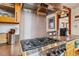 Gourmet kitchen range with stainless steel hood and dark countertops at 3777 Newton St, Denver, CO 80211