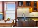 Farmhouse sink and butcher block island add charm to this cozy kitchen at 3777 Newton St, Denver, CO 80211
