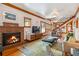 Cozy living room with a brick fireplace, wood trim, and hardwood floors at 3777 Newton St, Denver, CO 80211