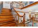 Elegant staircase boasts wood steps with decorative black wrought iron balusters and railing at 3777 Newton St, Denver, CO 80211