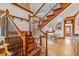 Elegant wooden staircase with black wrought iron spindles, connecting the home's levels at 3777 Newton St, Denver, CO 80211