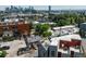 Aerial shot of neighborhood, highlighting rooftop deck, city skyline, and urban density at 1932 W 32Nd Ave, Denver, CO 80211
