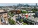 Aerial shot of a vibrant neighborhood with a cityscape backdrop and tree-lined streets at 1932 W 32Nd Ave, Denver, CO 80211