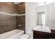 Modern bathroom with a combination tub and shower and sleek vanity at 1932 W 32Nd Ave, Denver, CO 80211