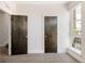 Bedroom featuring doors and a large window with neighborhood views at 1932 W 32Nd Ave, Denver, CO 80211