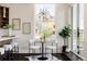 Bright dining area with modern lighting fixtures and a view of the city through large windows at 1932 W 32Nd Ave, Denver, CO 80211