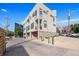Modern three-story townhome with neutral exterior, multiple windows, and attached garages at 1932 W 32Nd Ave, Denver, CO 80211