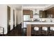 Modern kitchen featuring an island with seating, stainless steel appliances, and stylish cabinets at 1932 W 32Nd Ave, Denver, CO 80211