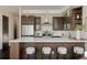 Kitchen featuring a central island with seating, stainless steel appliances, and stylish decor at 1932 W 32Nd Ave, Denver, CO 80211
