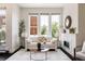 Bright living room with a fireplace, large windows and a comfortable seating area at 1932 W 32Nd Ave, Denver, CO 80211