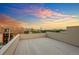 An expansive rooftop deck offering scenic city views at sunset, with a blue and orange sky at 1932 W 32Nd Ave, Denver, CO 80211
