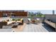 Comfortable rooftop deck furnished with cozy seating arrangements against a city backdrop at 1932 W 32Nd Ave, Denver, CO 80211