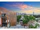 A scenic rooftop view of the city skyline beyond trees and adjacent architecture at 1932 W 32Nd Ave, Denver, CO 80211