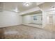 A finished basement with wall mirrors and neutral carpet, offering a versatile space for recreation or fitness at 2601 Pemberly Ave, Highlands Ranch, CO 80126