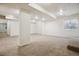 A large finished basement with carpet and recessed lighting, and a small window at 2601 Pemberly Ave, Highlands Ranch, CO 80126