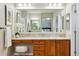 Bathroom featuring double vanity, granite countertops, and a large mirror at 2601 Pemberly Ave, Highlands Ranch, CO 80126